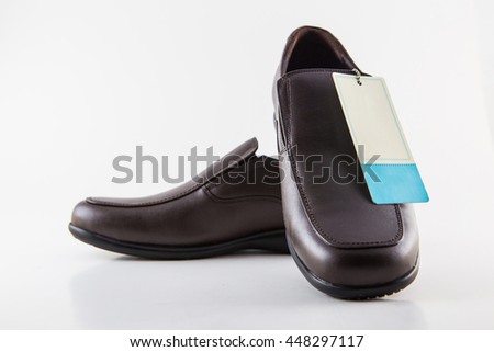 The new brown leather shoes (price tag) Royalty-Free Stock Photo #448297117