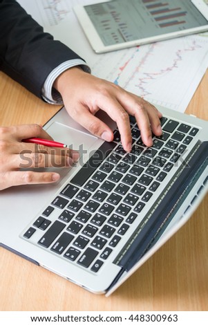 business man working at office with laptop and documents on his desk, consultant online marketing concept Royalty-Free Stock Photo #448300963