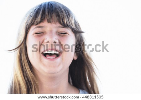 Close up portrait of girl laughing with eyes closed