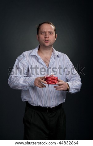 Sad man in shirt offering gifts studio shot