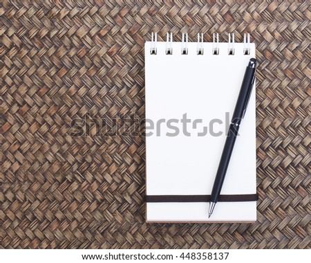 Notebook with space on bamboo weaving background.
