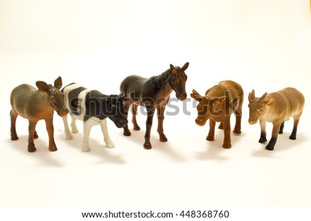 Toys made of plastic animals on a white background
