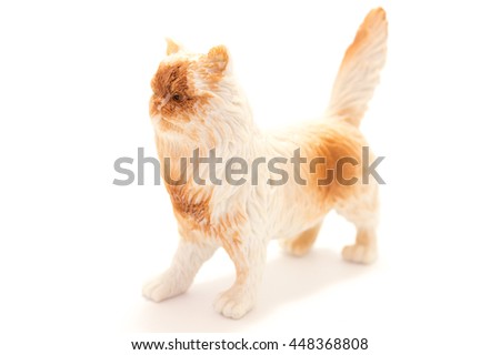 Toy cat from plastic on a white background