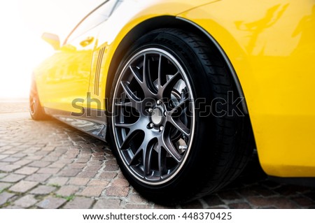 Back of a yellow modern sport car in sunset Royalty-Free Stock Photo #448370425