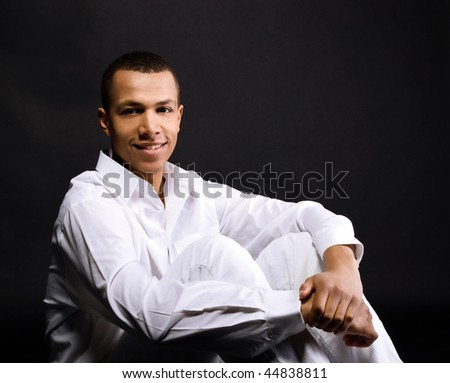 Smiling young men isolated on black background