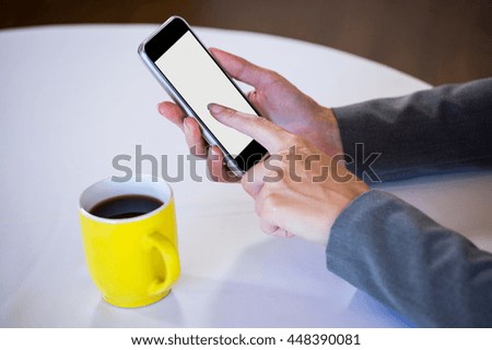 Woman taking a picture of coffee in a restaurant