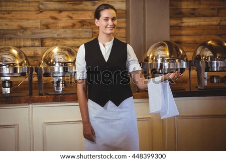 Smiling waitress standing in a restaurant