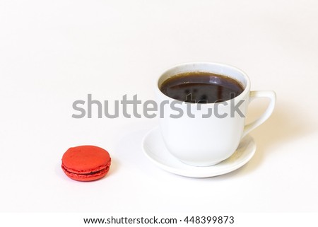 Cup of coffee and red macaron isolated on white background