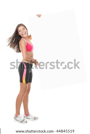 Beautiful fitness woman holding white blank sign / banner. Gorgeous smiling and energetic mixed race chinese / caucasian model isolated on white background.