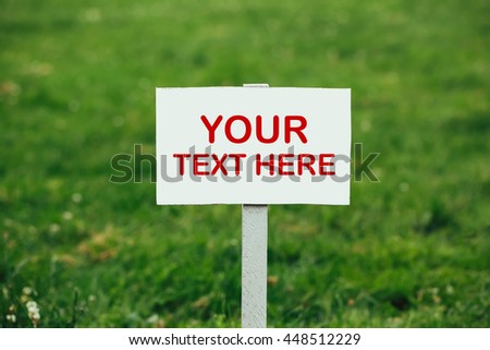 your text here sign against green grass background