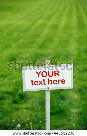 your text here sign against green lawn background