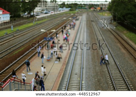 Blurred people crossing the railroad to the platform