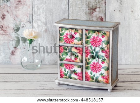 Decoupaged jewellery armoire in a shabby chic style