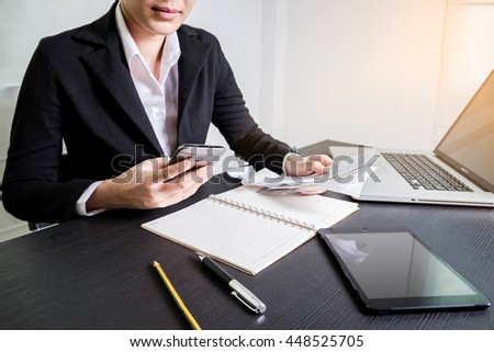 Bussiness concept, Bussiness woman working with smart phone and bill on wooden table
