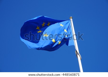 Flag of the European Union - blue flag with stars and cloudless sky.