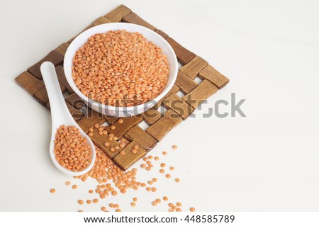 Masoor Dal in a bowl isolated on white background with spoon and table mat  Royalty-Free Stock Photo #448585789
