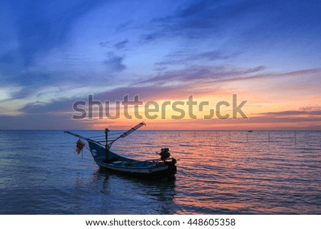 Colorful sky  in lake reflected and the boat in morning time before sunrise,Select focus with shallow depth of field,Soft focus,noise and grain due long exposure:ideal use for background.