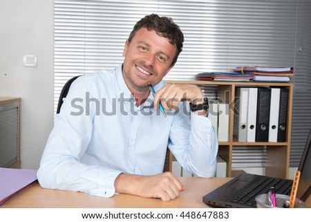 Serious doubtful businessman thinking and looking camera sitting in a desk at office Royalty-Free Stock Photo #448647883