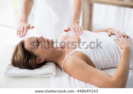 Woman receiving Reiko treatment at spa
