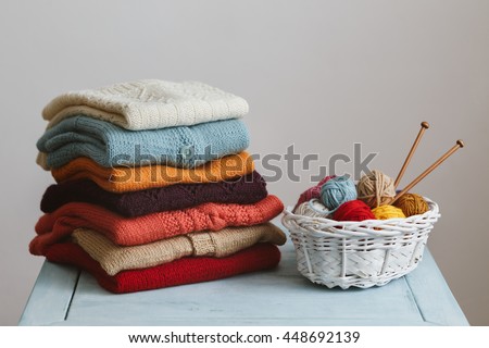 Knitted sweaters with knitting needles and wool Royalty-Free Stock Photo #448692139