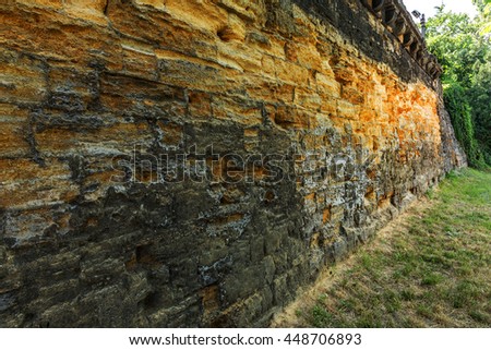 Texture of old stone wall yellow coquina with traces of erosion in the long term. Traces of the destruction of the structure. As background for creative design. selective focus