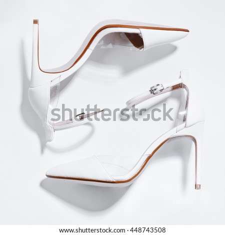White bridal fashion shoes isolated on white background. Creative flat lay photo.  Royalty-Free Stock Photo #448743508