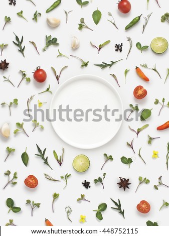 Flat lay fresh vegetables, herbs and spices with a empty white plate on white background. Text space images. Royalty-Free Stock Photo #448752115