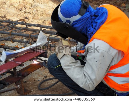 Welding work,worker with protective welding metal on construction site
