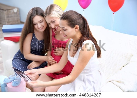 Pregnant woman and friends at baby shower party