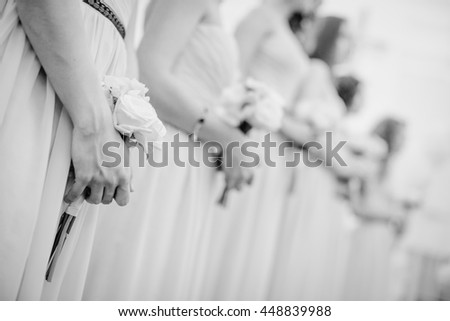Black and white picture of bridesmaids standing in a ray