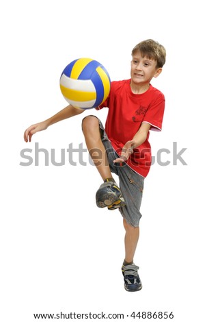 Boy in red shirt playing with a soccer ball.