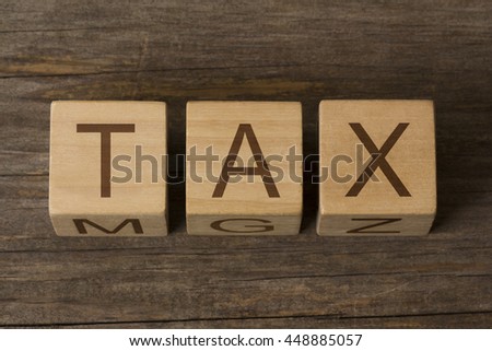 Tax written on a wooden cubes