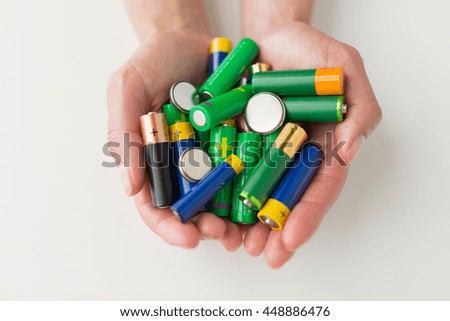 recycling, energy, power, environment and ecology concept - close up of hands holding alkaline batteries heap Royalty-Free Stock Photo #448886476