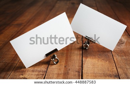 Photo of blank business cards on vintage wood table background. Mock up for ID. Blank template for branding identity for designers.