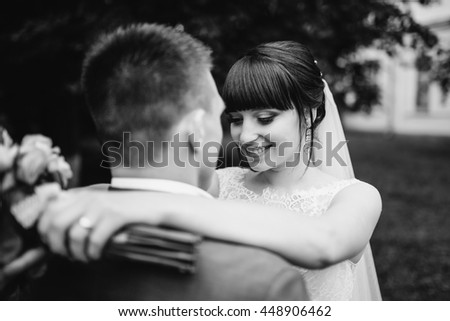 Bride and groom at wedding Day walking Outdoors on summer nature. Bridal couple, Happy Newlywed woman and man embracing. Loving wedding couple outdoor. 