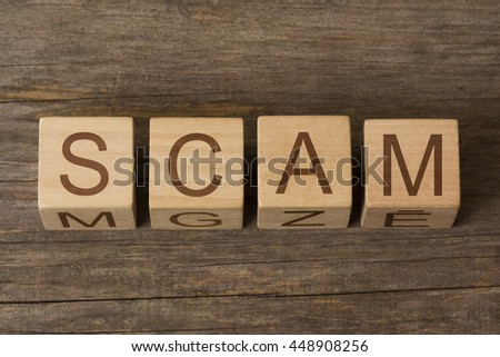 SCAM word in vintage wooden blocks