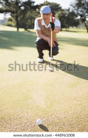 Blurred picture of sportsman analysing the field on a golf course