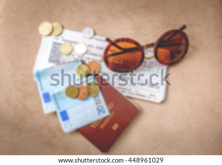 Travel concept, blurred photo of passport, money, tickets, card and sunglasses to use s background
