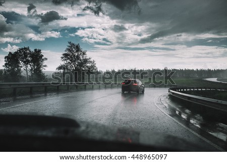 Drive car in rain on curve asphalt wet road