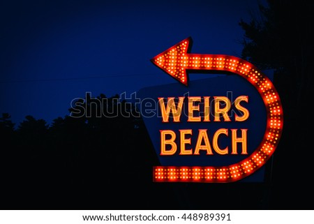 The Weirs Beach sign at night, in Laconia, New Hampshire.