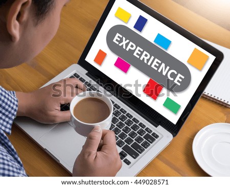 EXPERIENCE Businessman at work. Close-up top view of man working on laptop while sitting at the wooden desk , coffee