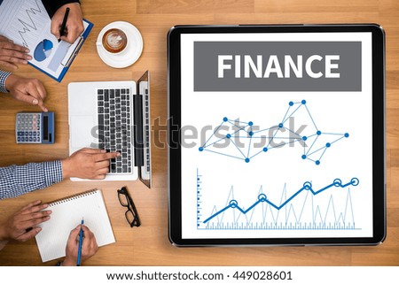 Finance bar graph chart investment money Business team hands at work with financial reports and a laptop