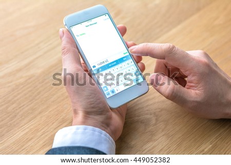 businessman edits message on mobile phone 