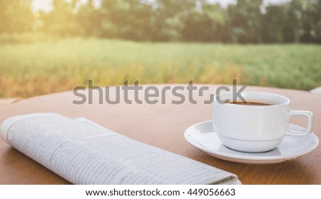 coffee white cup,on the table ,background forest and solar light in the morning