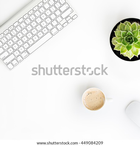 White office desk table with wireless aluminum keyboard, mouse, cup of coffee and succulent flower in pot. Top view with copy space. Flat lay.
 Royalty-Free Stock Photo #449084209