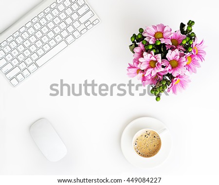 White office desk table with wireless aluminum keyboard, mouse, cup of coffee and  flower bouquet in pot. Top view with copy space. Flat lay. Royalty-Free Stock Photo #449084227