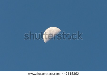 blurred half moon on blue sky background