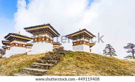 Dochula pass 108 chortens (Asian stupas) is the memorial in honour of the Bhutanese soldiers  in the Timpu city with the grass landscape and cloudy sky background, Bhutan