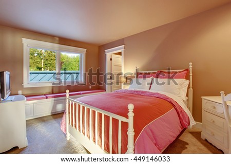 Adorable girls room with pink walls, white furniture set and red bedding.