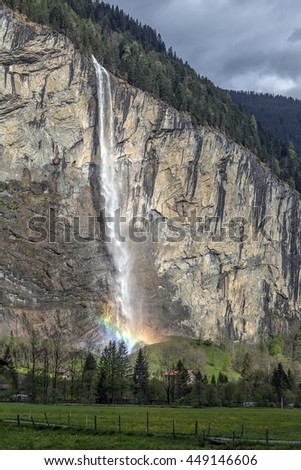 Famous touristic village with high waterfall in background, Lauterbrunnen, Switzerland, Europe